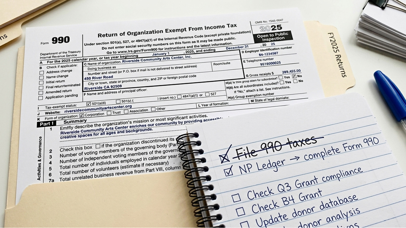 Completed IRS Form 990 filing scene with checklist and paperwork organized for submission.